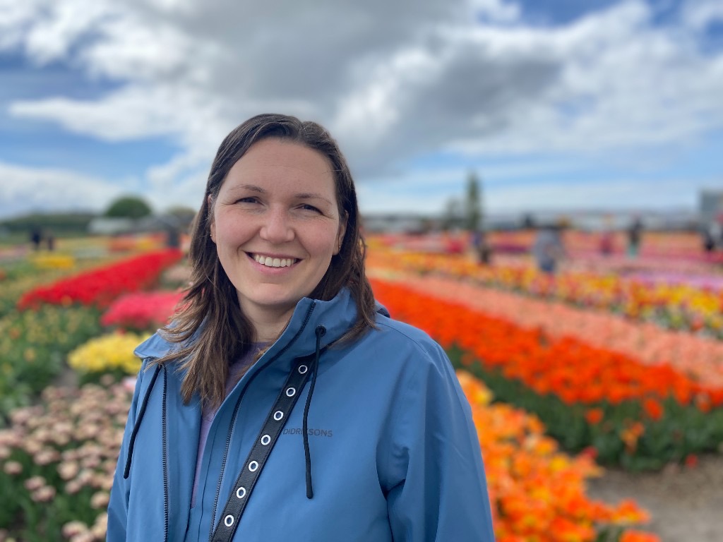 Kristina, founder of Laumė, in a field of tulips